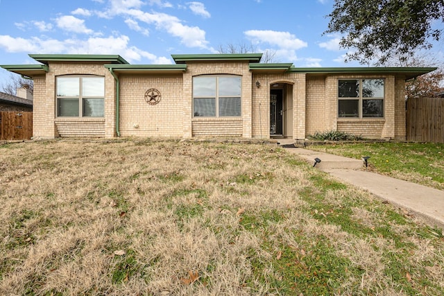 ranch-style house with a front lawn