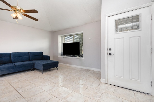 living room with a textured ceiling, vaulted ceiling, and ceiling fan