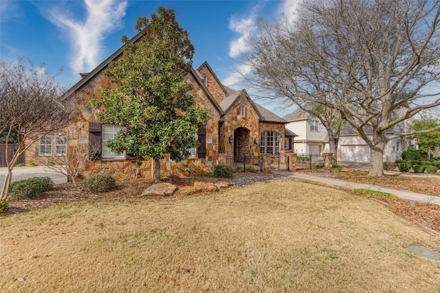 tudor-style house featuring a front lawn