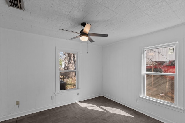 empty room featuring ceiling fan and dark wood-type flooring