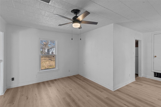 empty room with light wood-type flooring and ceiling fan