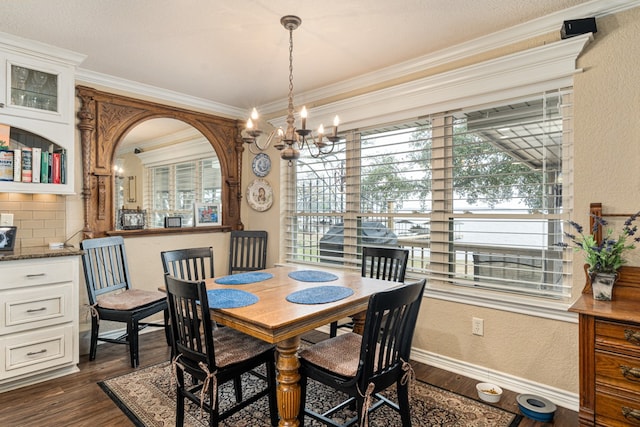 dining space with crown molding, dark wood-type flooring, and an inviting chandelier