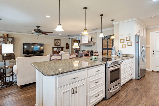 kitchen with appliances with stainless steel finishes, stone countertops, hanging light fixtures, and white cabinets