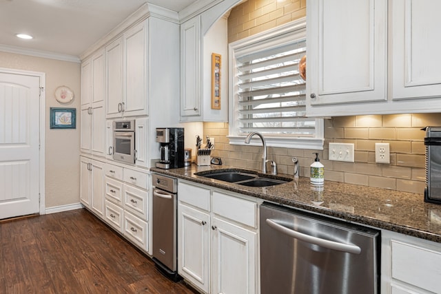 kitchen with white cabinetry, sink, dark hardwood / wood-style flooring, dark stone counters, and stainless steel appliances