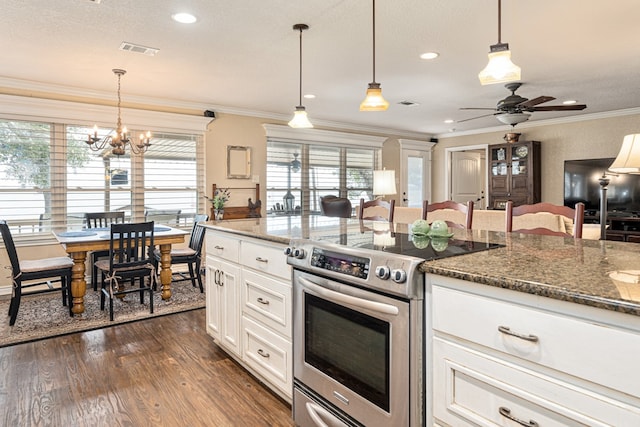 kitchen with crown molding, decorative light fixtures, stainless steel electric range, dark stone counters, and white cabinets