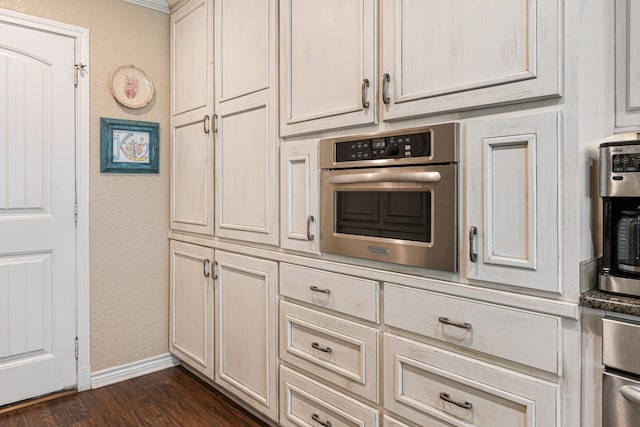 kitchen featuring dark hardwood / wood-style flooring and oven