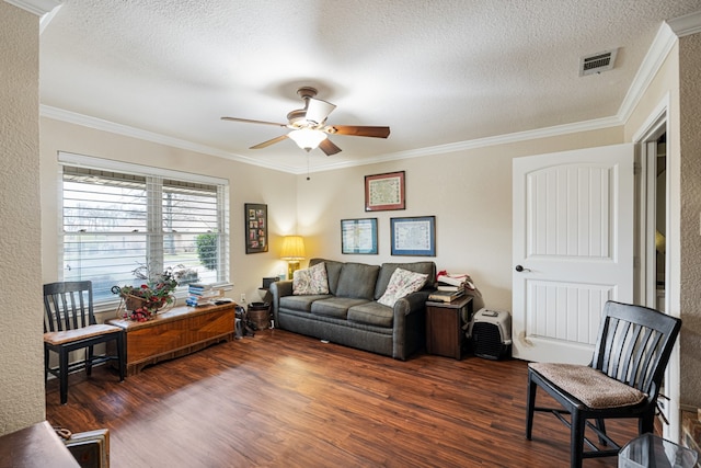 living room with crown molding, dark hardwood / wood-style floors, a textured ceiling, and ceiling fan