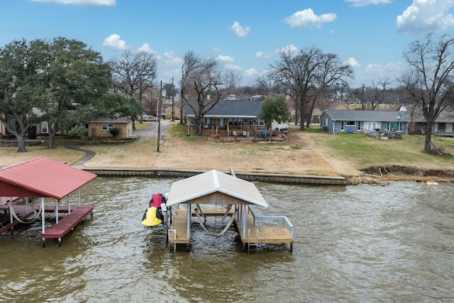 dock area with a yard and a water view