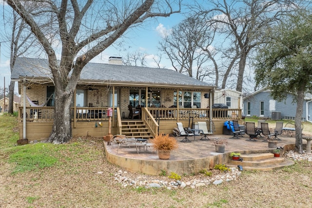 rear view of house with a patio area and central air condition unit