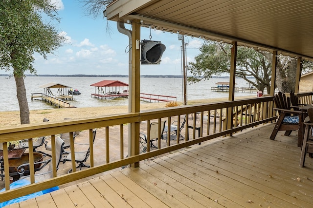 wooden terrace featuring a water view