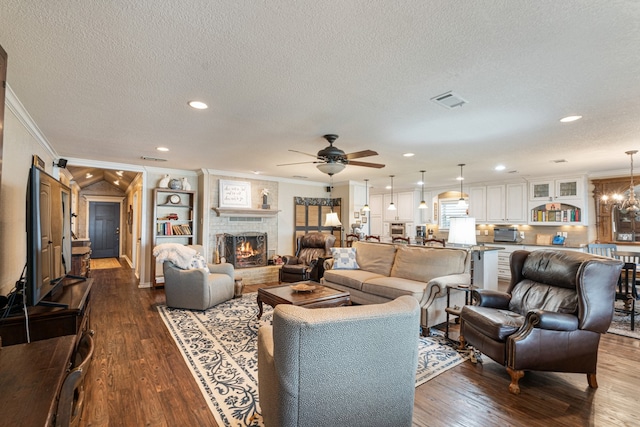 living room featuring crown molding, wood-type flooring, and a fireplace