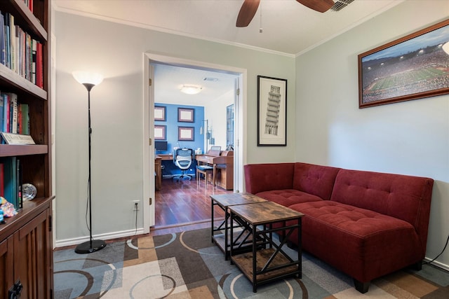 living room with hardwood / wood-style flooring, ornamental molding, and ceiling fan