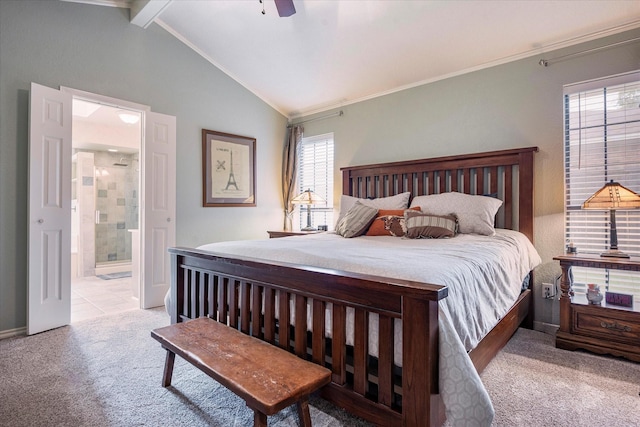 bedroom featuring crown molding, light colored carpet, lofted ceiling with beams, and ensuite bath