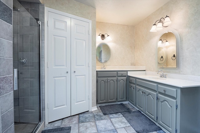 bathroom featuring vanity and a shower with door