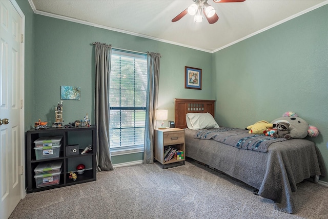 bedroom featuring ceiling fan, ornamental molding, and carpet flooring