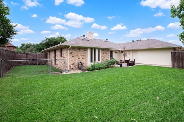 rear view of house featuring outdoor lounge area and a yard