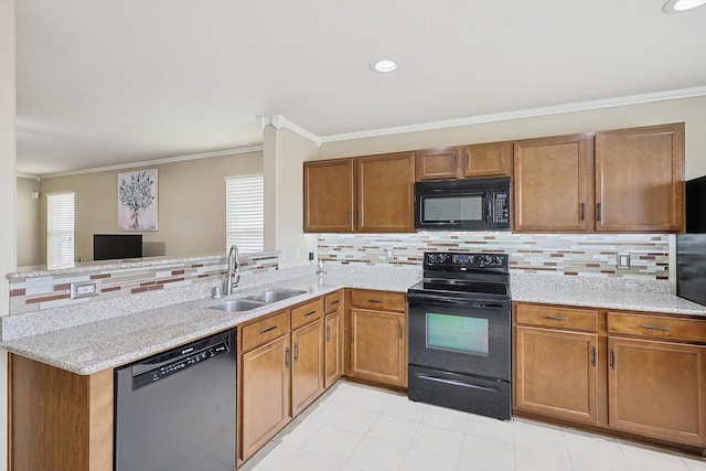 kitchen with crown molding, sink, kitchen peninsula, and black appliances