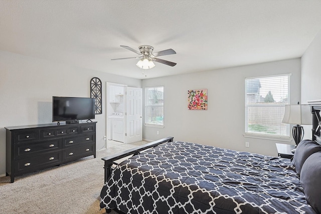 bedroom with multiple windows, washer / clothes dryer, ceiling fan, and carpet