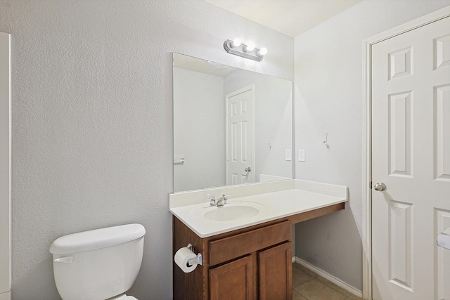 bathroom featuring vanity, toilet, and tile patterned flooring