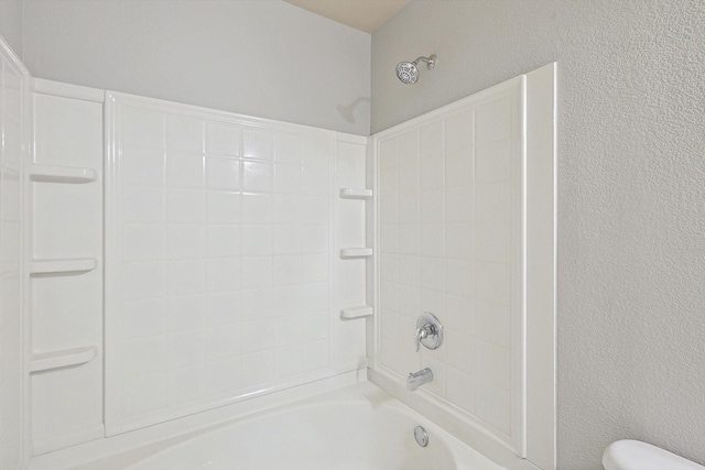 bathroom featuring toilet and shower / bath combination