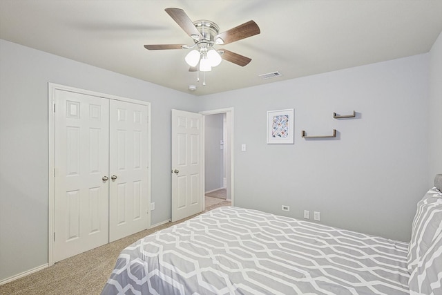 carpeted bedroom featuring a closet and ceiling fan