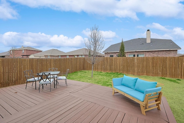 wooden deck with an outdoor living space and a yard