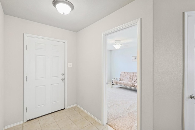 doorway with light tile patterned floors