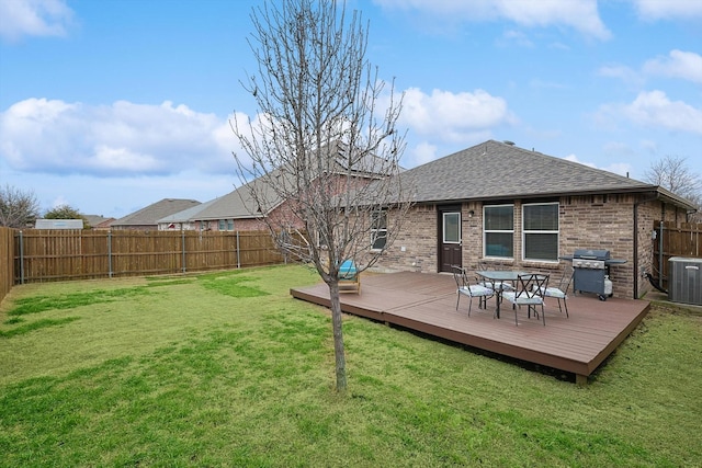 back of property with central AC unit, a yard, and a deck