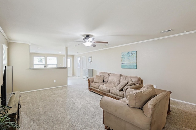 carpeted living room with crown molding and ceiling fan