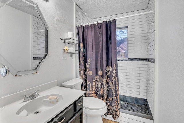 bathroom with vanity, a textured ceiling, toilet, and walk in shower