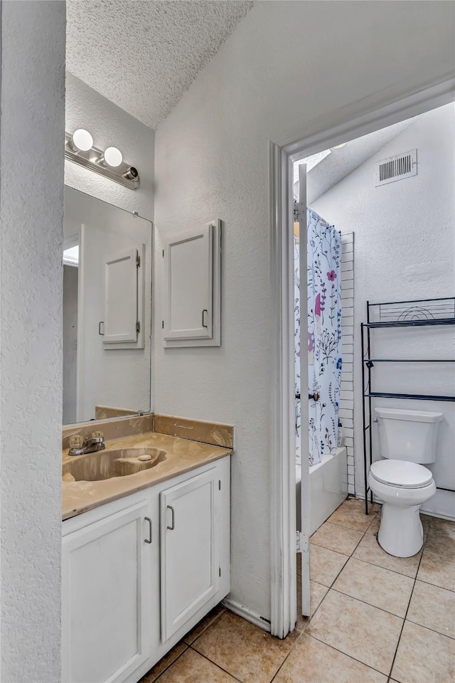 full bathroom featuring tile patterned floors, toilet, a textured ceiling, vanity, and shower / bath combination with curtain