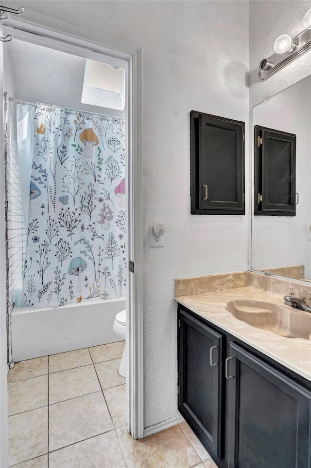 full bathroom with tile patterned floors, toilet, shower / bath combo with shower curtain, and vanity