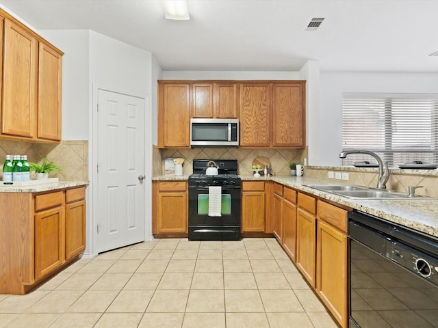 kitchen featuring light tile patterned floors, tasteful backsplash, visible vents, black appliances, and a sink