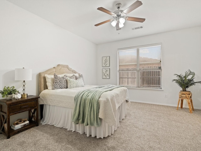 bedroom with light carpet, a ceiling fan, visible vents, and baseboards