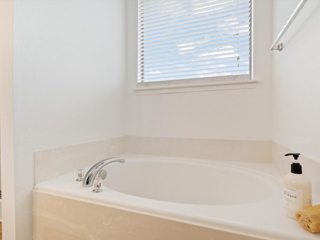 full bathroom featuring a garden tub and a wealth of natural light