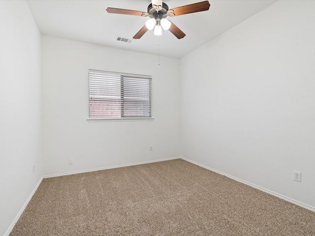 empty room featuring ceiling fan, carpet floors, visible vents, and baseboards