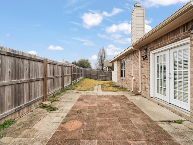 view of patio / terrace with french doors and a fenced backyard