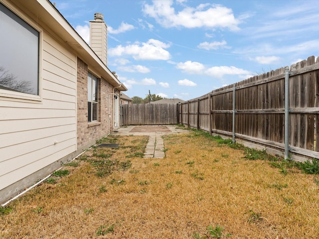 view of yard with a fenced backyard