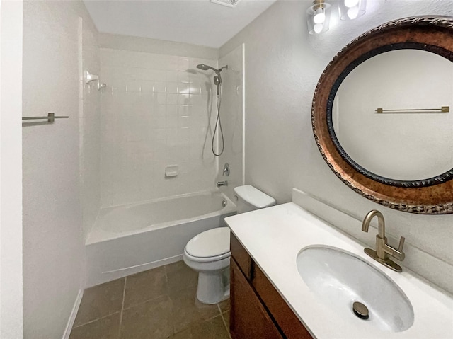 full bathroom featuring tile patterned flooring, tiled shower / bath, vanity, and toilet