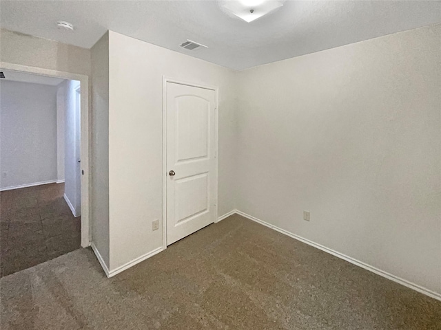 empty room with dark carpet