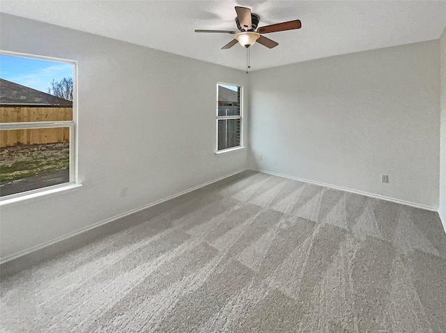 carpeted empty room featuring ceiling fan