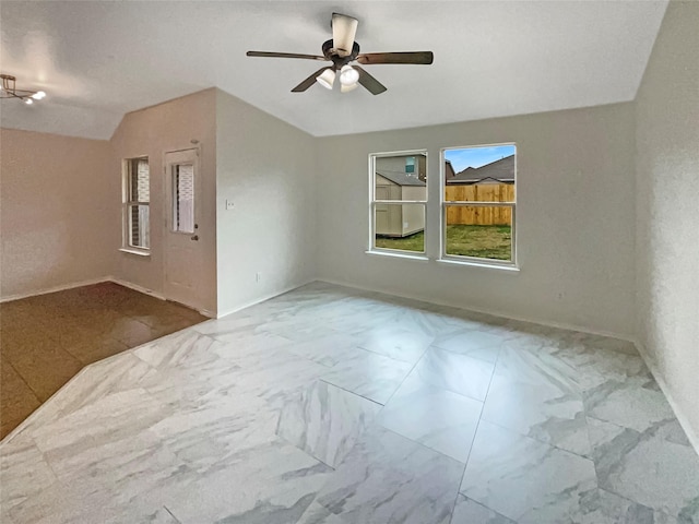 unfurnished room with vaulted ceiling and ceiling fan