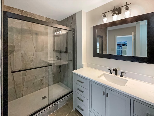 bathroom featuring vanity, tile patterned flooring, and a shower with door