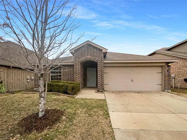 view of front of property featuring a garage and a front lawn