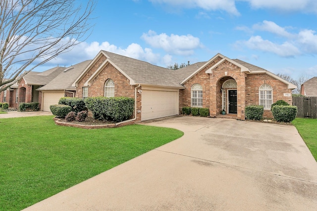 view of front of house featuring a garage and a front lawn