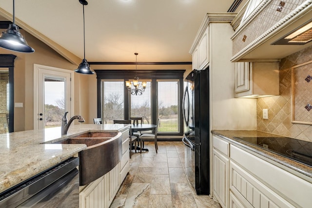 kitchen featuring pendant lighting, backsplash, cream cabinetry, and black appliances