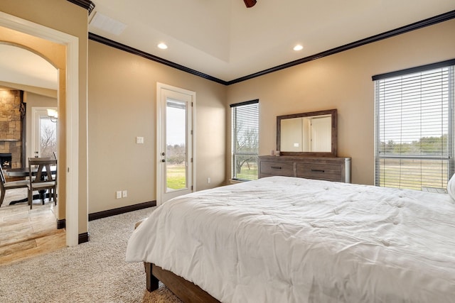 carpeted bedroom featuring access to exterior, a fireplace, and ornamental molding