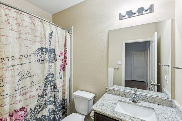 bathroom with vanity, toilet, and a shower with shower curtain