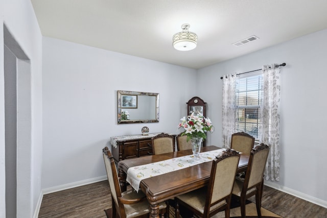 dining area with dark hardwood / wood-style floors