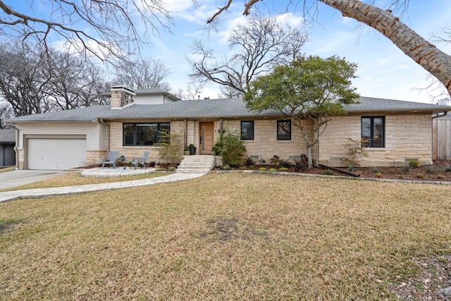 view of front of property featuring a garage and a front yard